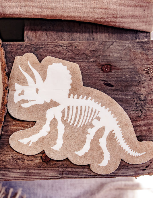 Détail du motif des serviettes dinosaures squelette tricératops