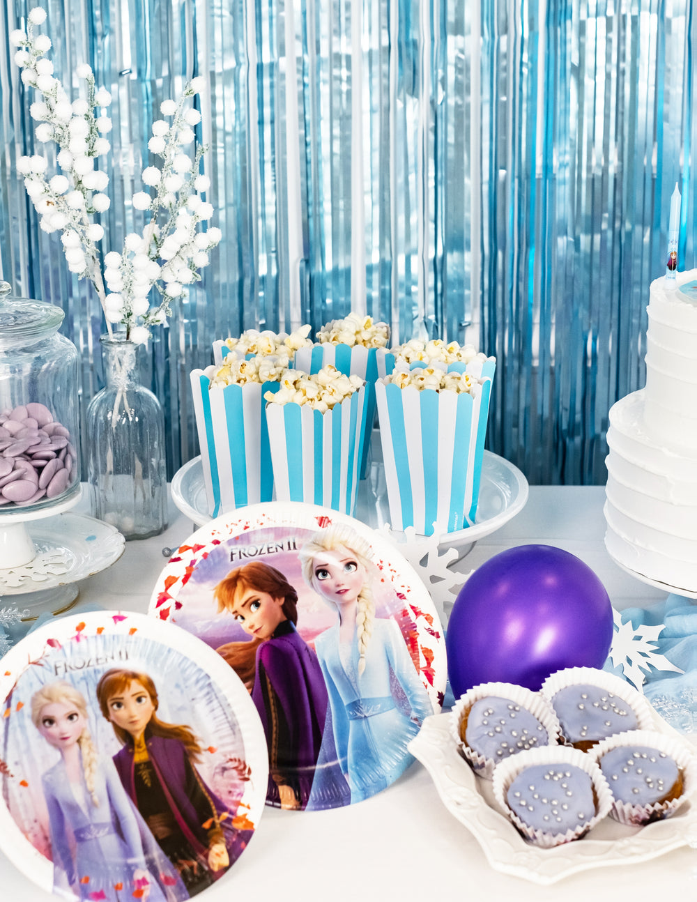 Mise en situation sur une table de fête des boîtes à popcorn à rayures pour fête bleu et blanc turquoise
