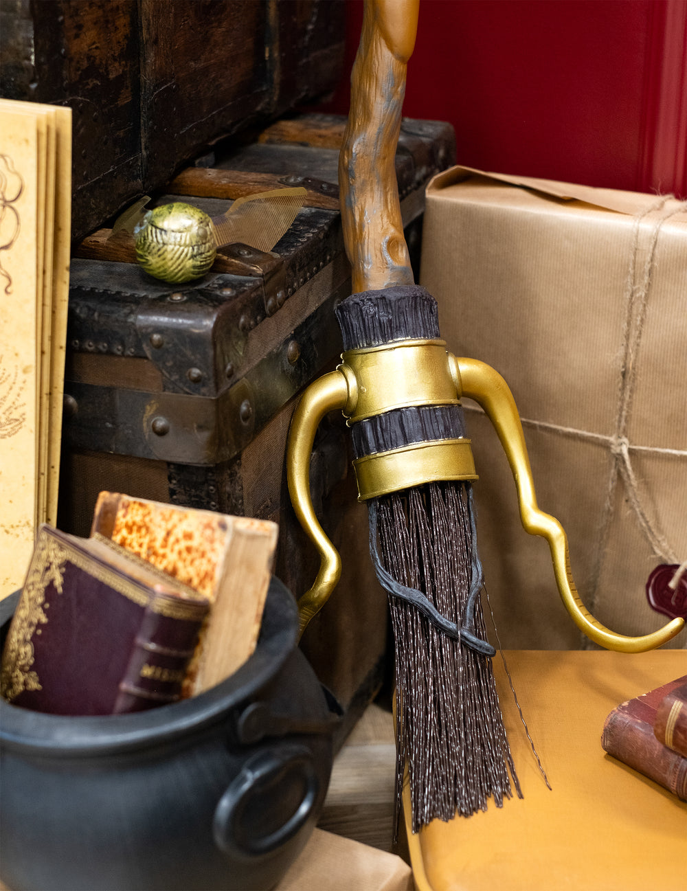 Gros plan sur les repose-pieds dorés et les poils du balai Nimbus luxe Harry Potter