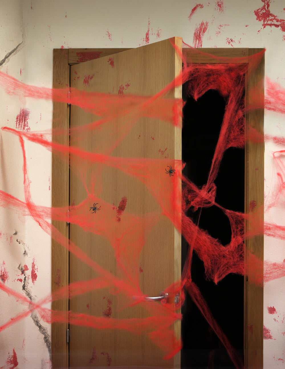Décoration toile d'araignée Halloween rouge avec araignées noires