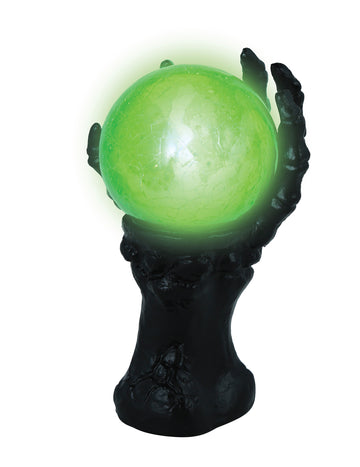 Črna okostnja roka s svetlečo kristalno kroglo