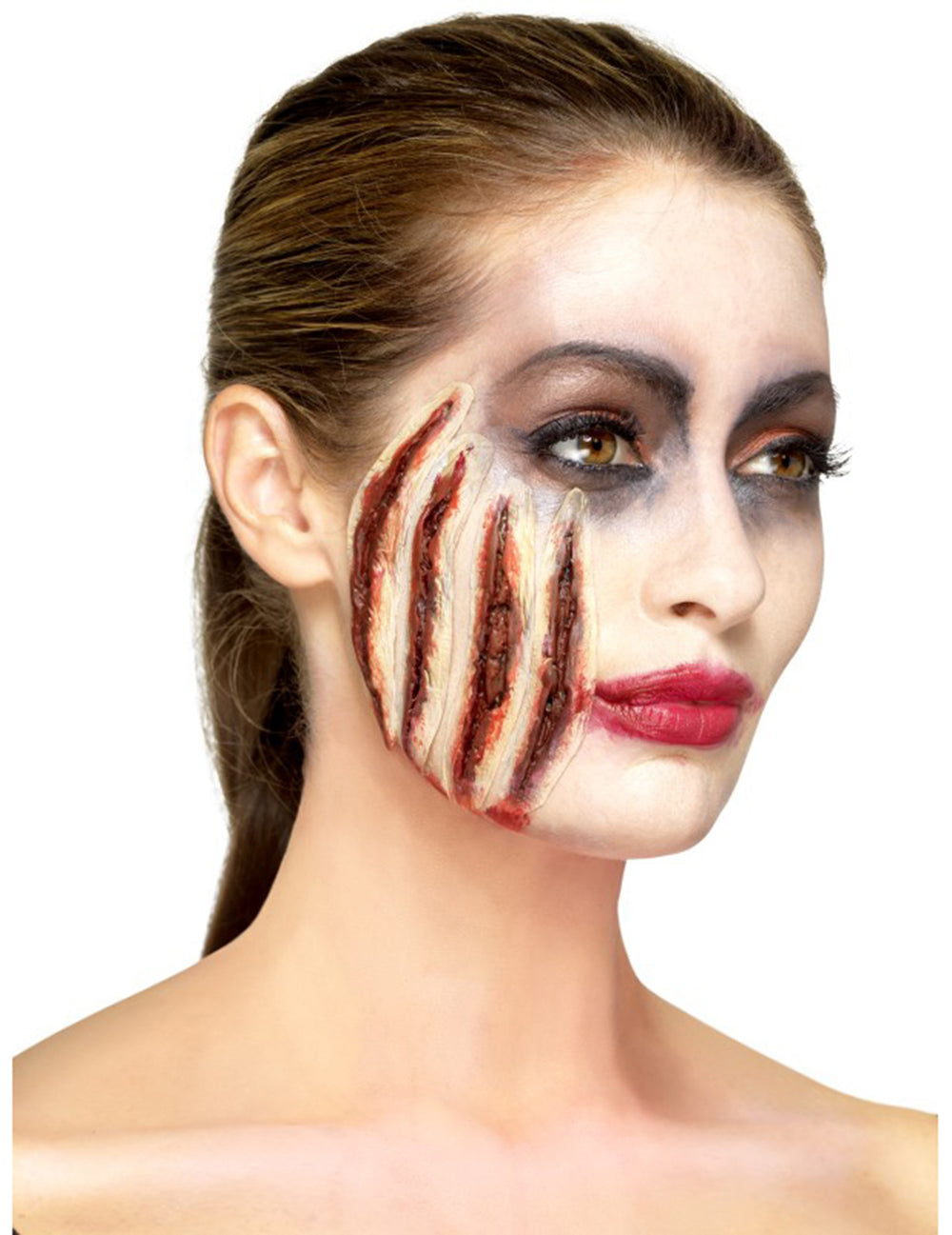 Vue de profil de la prothèse latex entailles Halloween