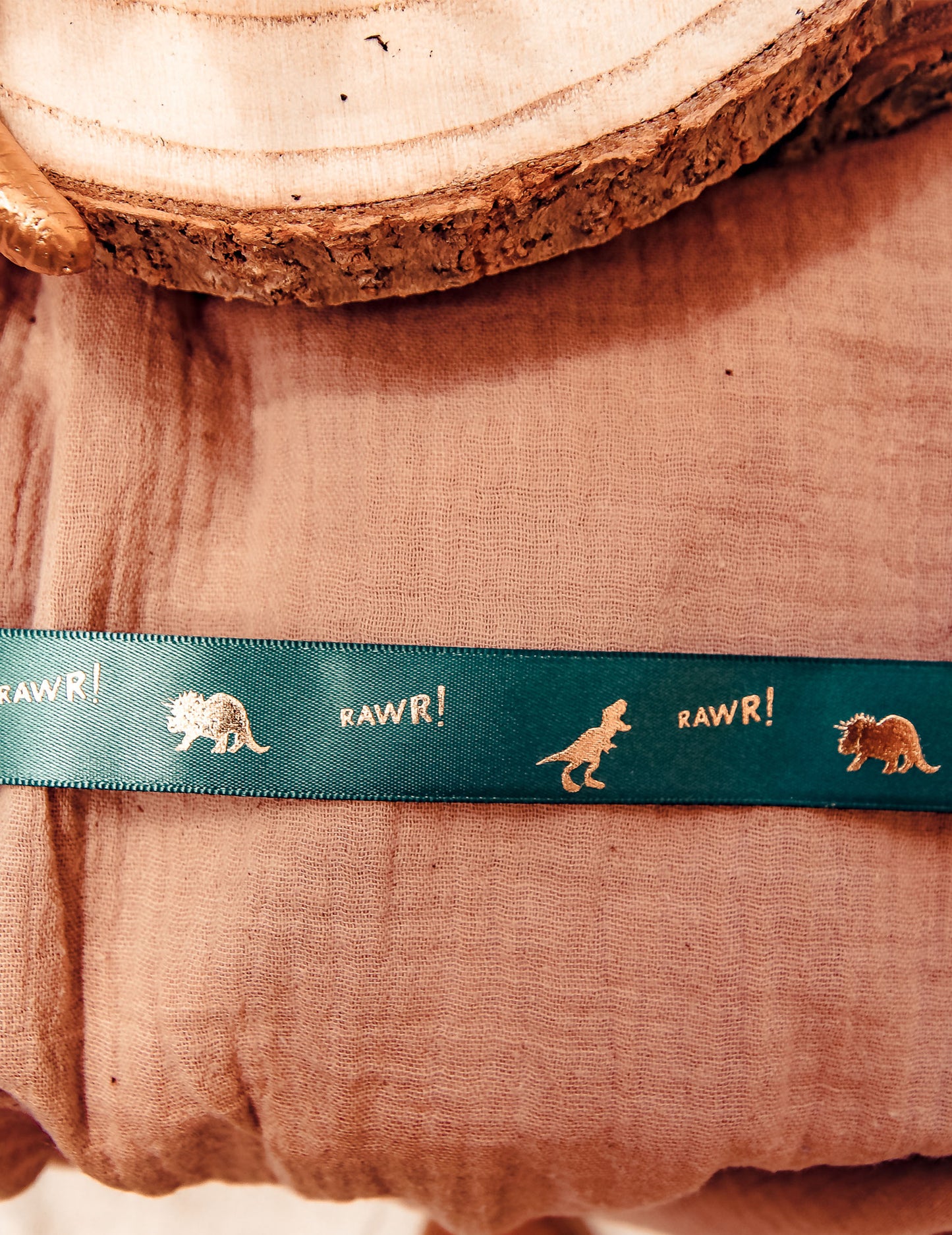 Mise en situation du ruban en satin dinosaure et RAWR ! vert floqué or