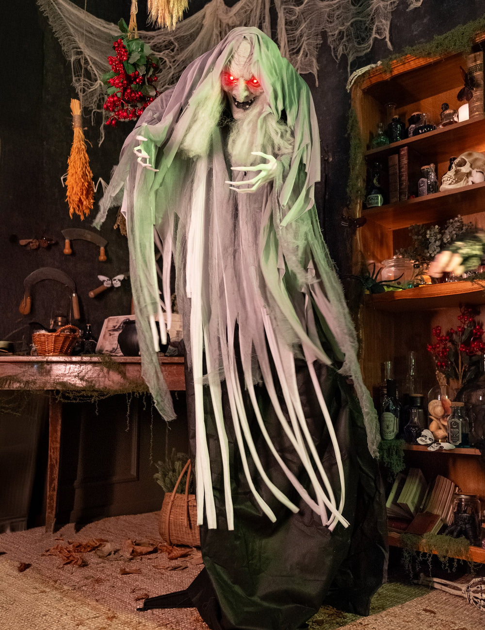 Sorcière animée pour décoration d'Halloween verte et grise aux yeux rouges
